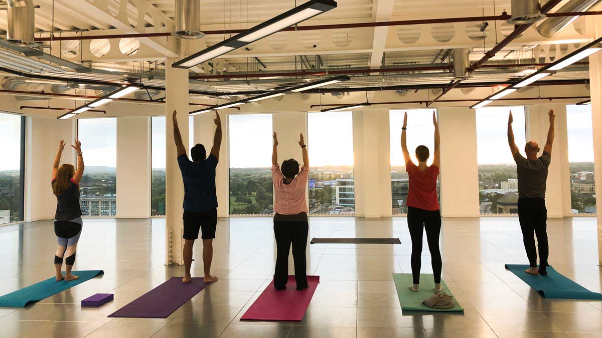 Worker wellbeing - Arms up yoga at work